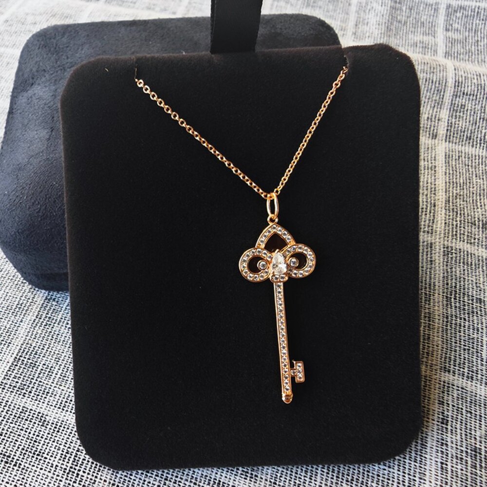 Tiffany & Co. 18k Gold Diamond Key Pendant